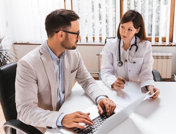 Two doctors talking at a desk